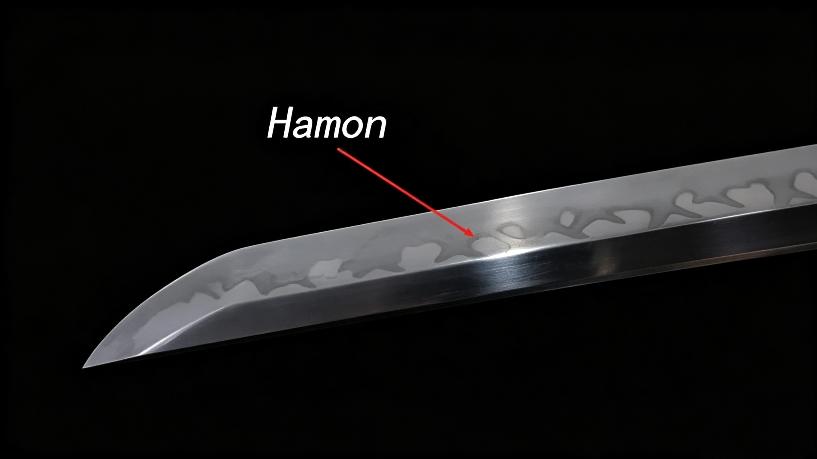 Close-up polished katana blade with red arrow marking distinct hamon temper line against solid black background