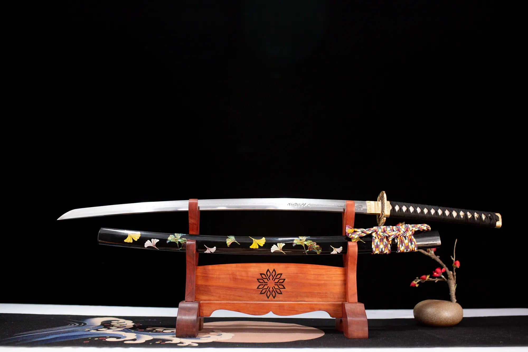 Black katana with flowers painted on it