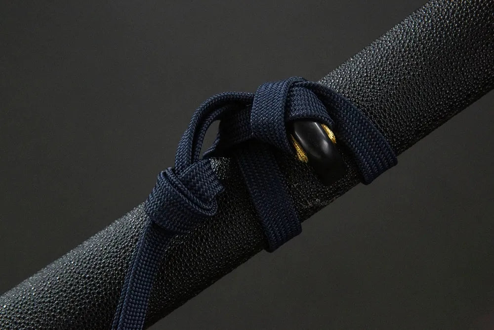 Plain woven cotton sageo cord tied around saya ring of Yamato entry katana