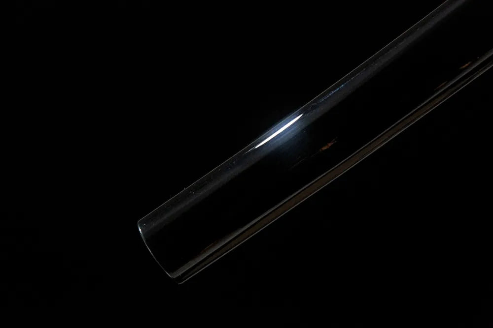 Bottom saya closeup plain solid wood scabbard end