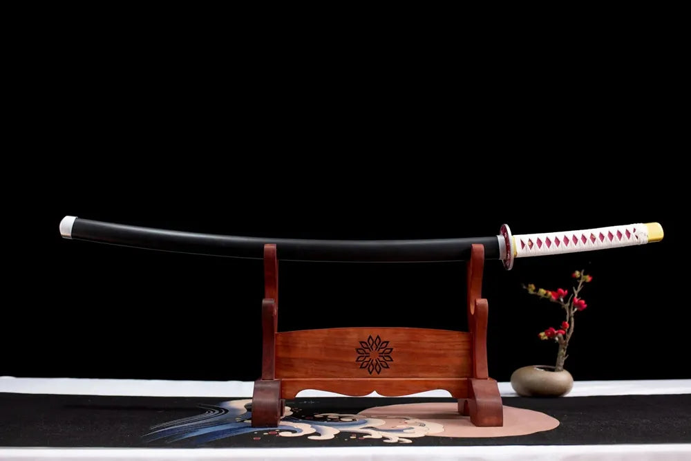 Horizontal laid closed pale cherry‑blossom print Kanawo scabbard flat table display