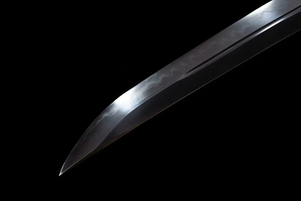 Compact functional wakizashi‑style kissaki tip of Dragon‑Wakizashi blade close‑up view