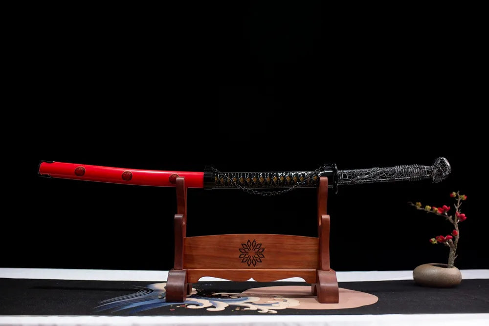 Horizontal laid closed bright‑red family‑mon Skeleton‑Demon‑King‑Katana scabbard flat table‑top front display