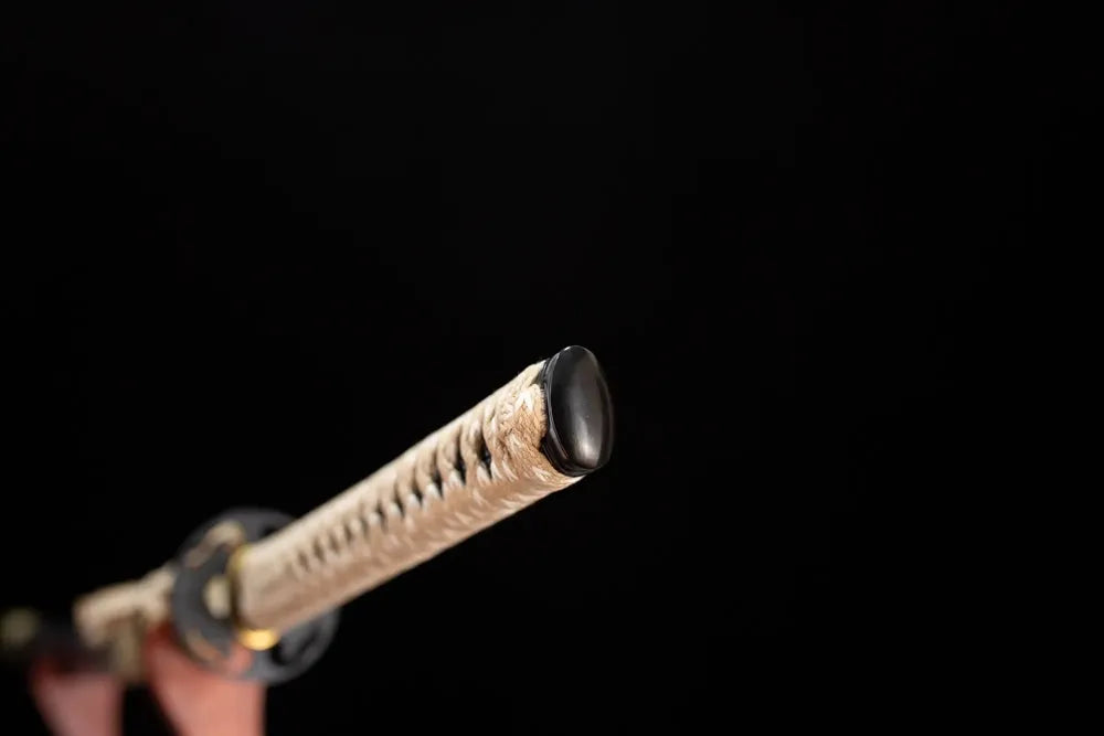 Smooth polished solid‑black iron pommel‑cap detail shot