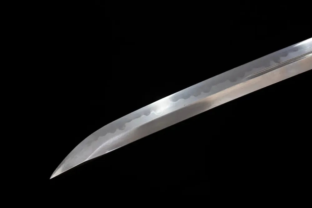 Slender tapered komaru‑boshi kissaki tip of Purgatory‑Katana blade close‑up view