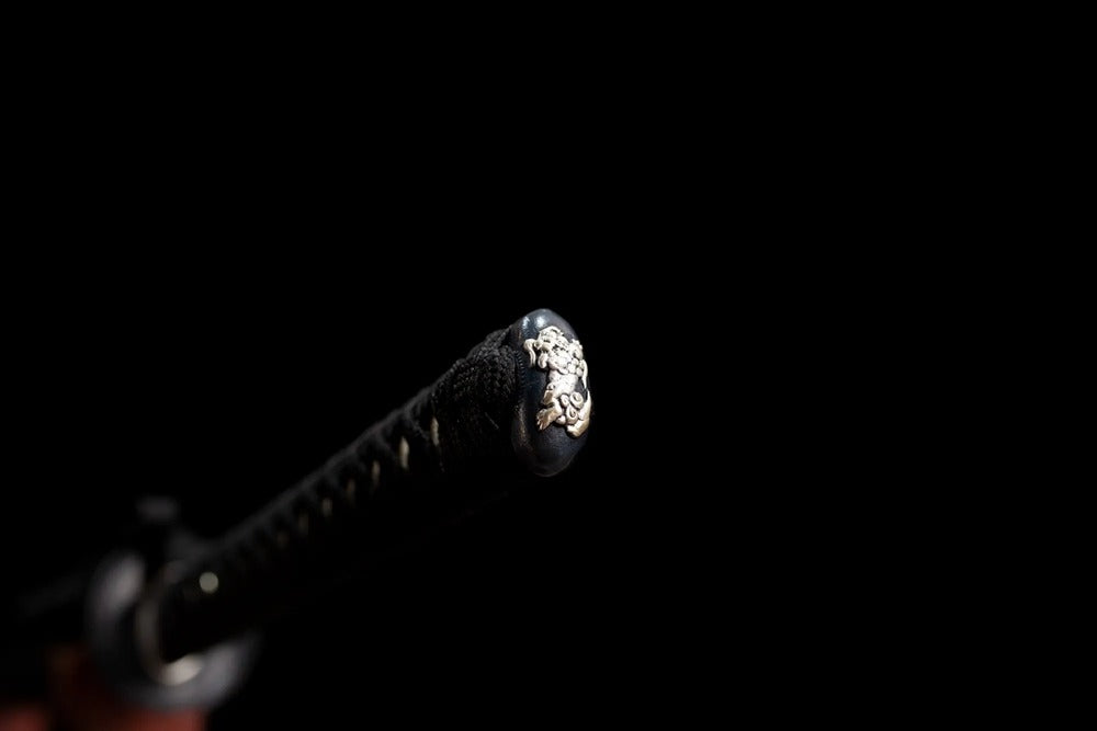 Shishi‑lion‑relief copper‑alloy pommel‑cap detail shot