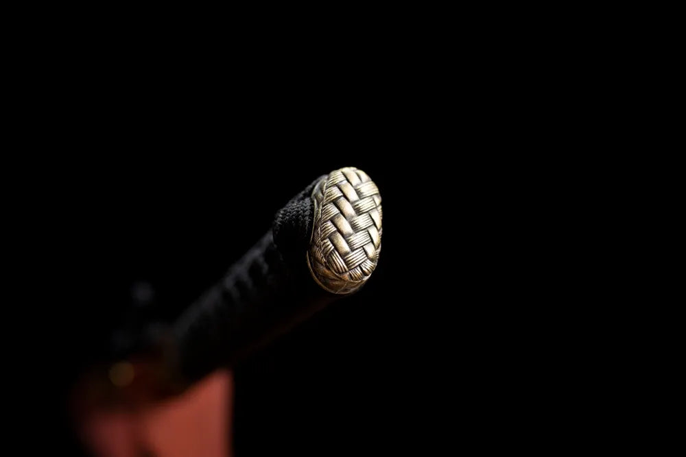 Simple functional antique‑bronze alloy pommel‑cap detail shot