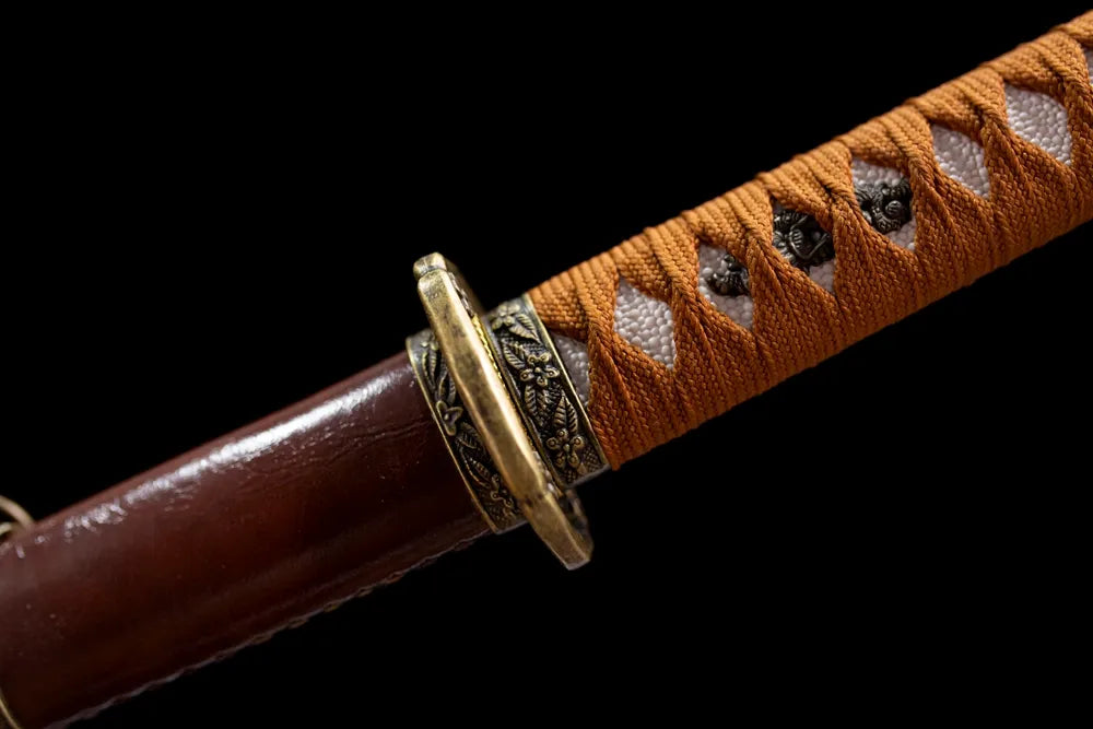 Floral‑ornament vintage‑brass shin‑gunto fuchi grip‑ring macro close‑up