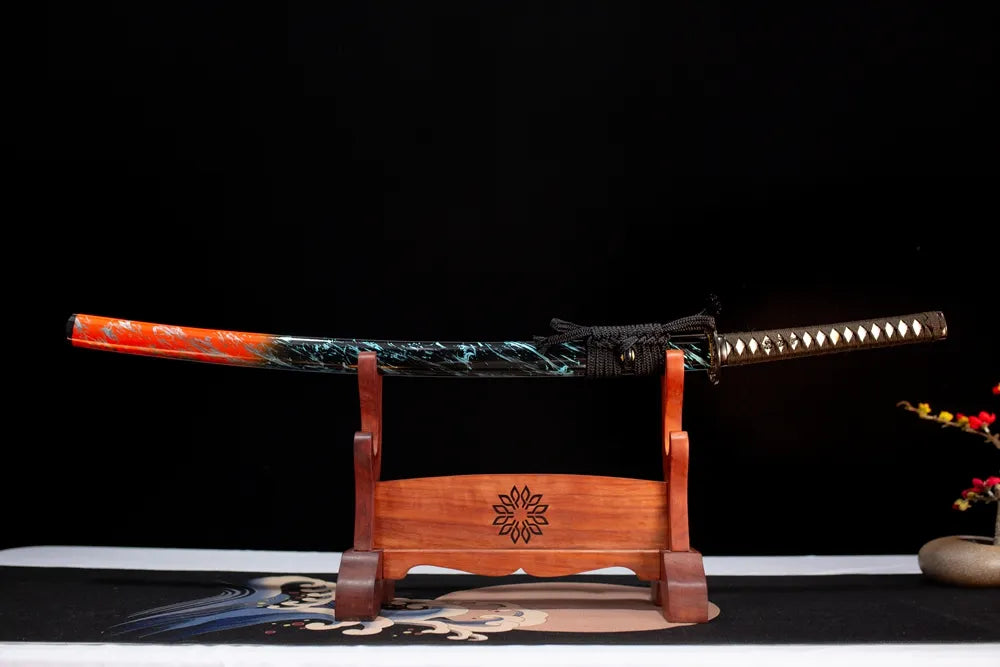 Horizontal laid closed orange‑red‑gradient flame‑streamer Battle‑Frenzy‑Katana scabbard flat table‑top front display