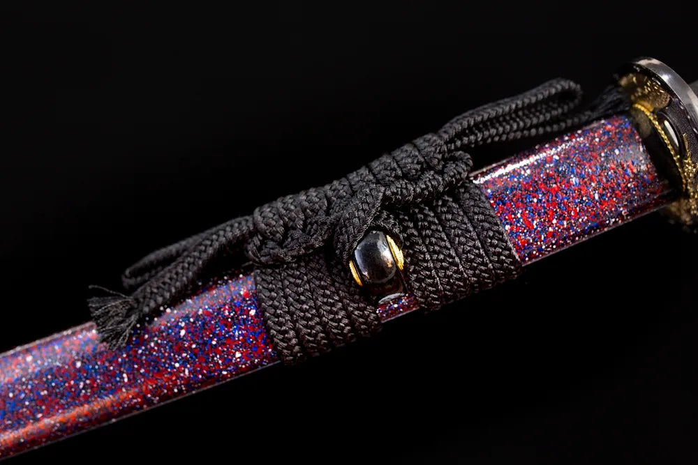 Thick black‑braided sageo cord gilded‑alloy fitting macro close‑up‑long katana