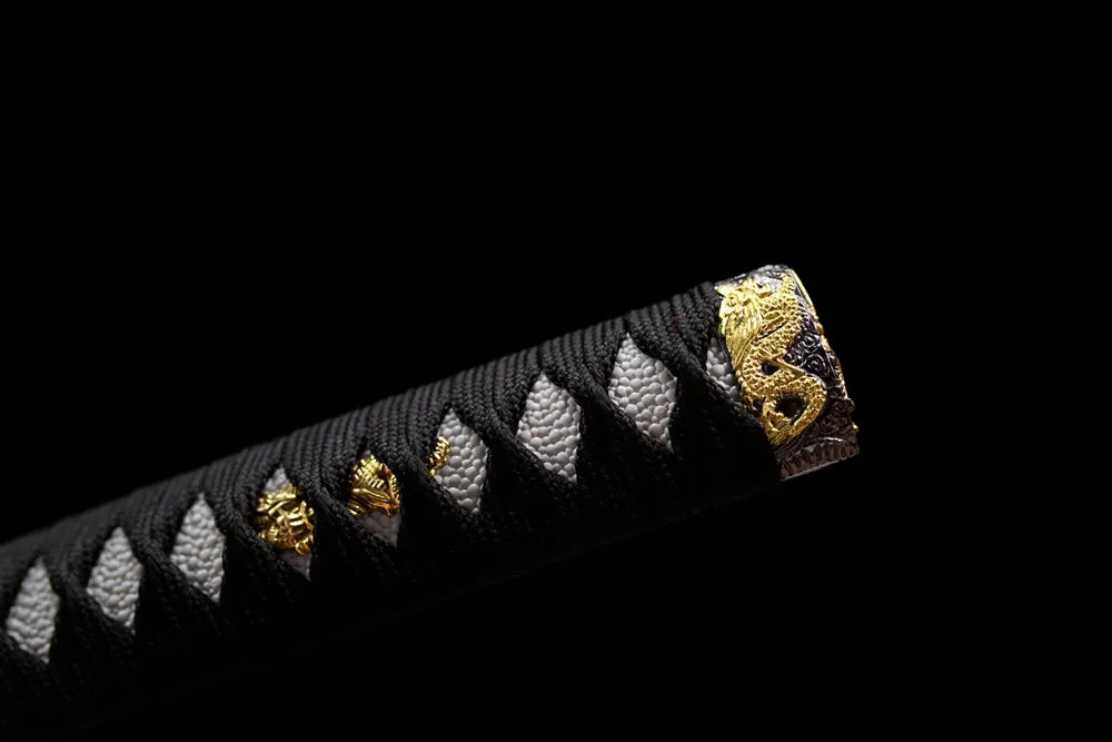 Top warrior‑figure gilded‑alloy kashira pommel front close‑up