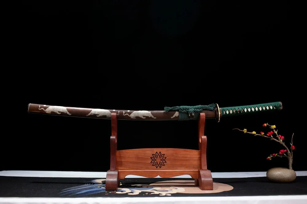 Horizontal laid closed brown hardwood silver‑etched running‑tiger Forest‑Tiger‑Katana scabbard flat table‑top front display