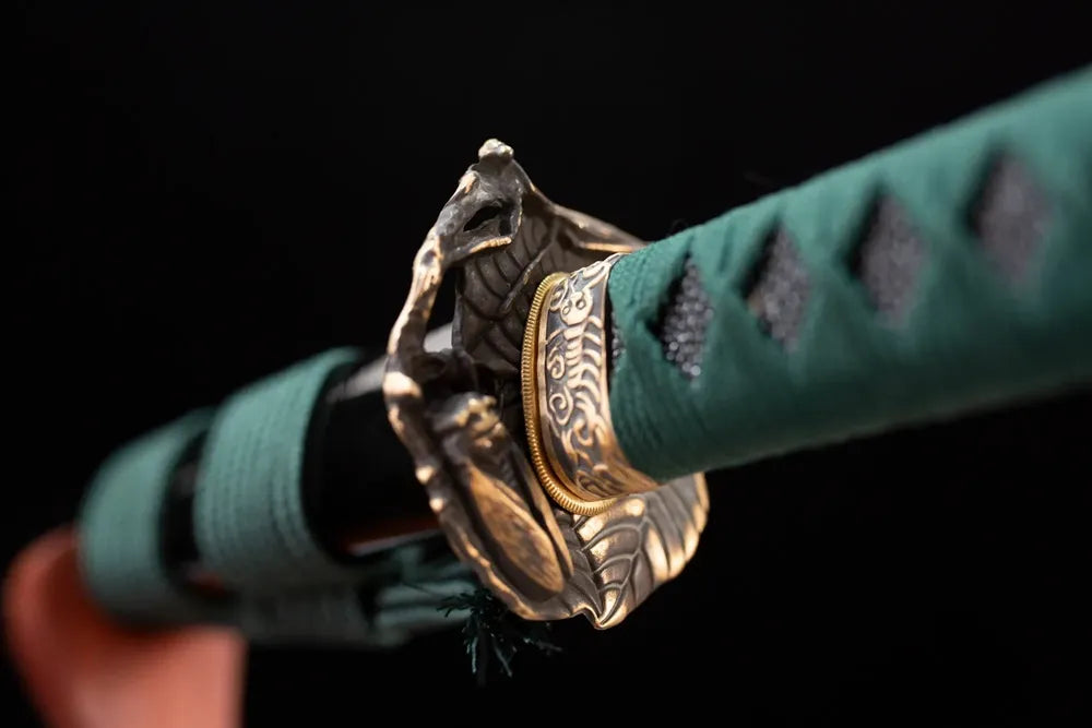 Reverse‑side wild‑grass‑insect carving aged‑teal‑bronze tsuba surface texture close‑up