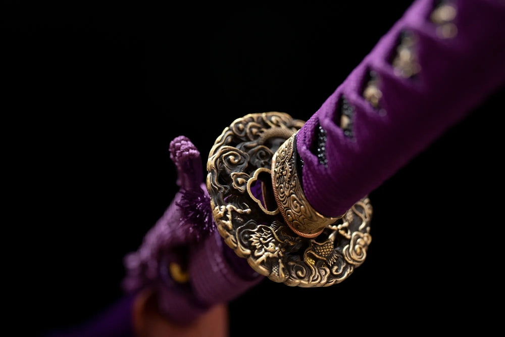Reverse‑side wisteria‑scroll carving purple‑toned purple‑gild tsuba surface texture close‑up