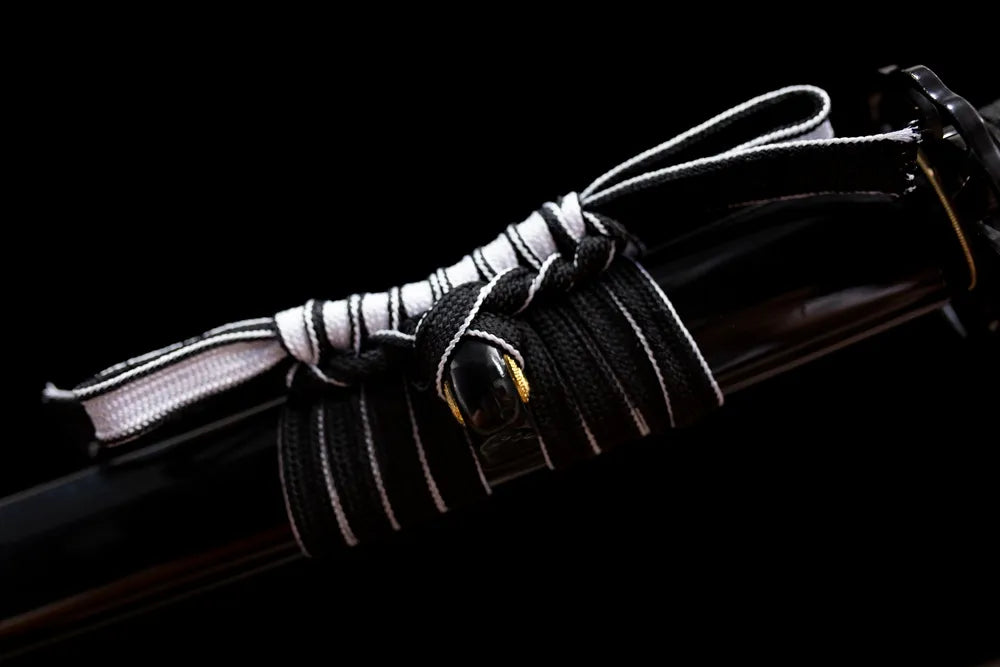 Thick pure‑black braided sageo cord aged‑alloy fitting macro close‑up