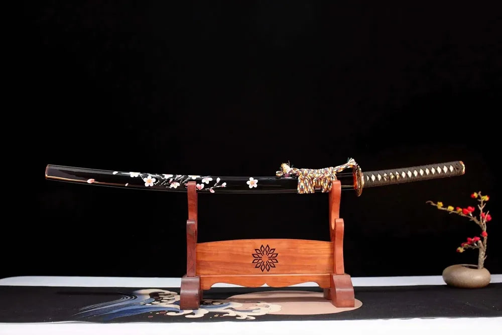 Horizontal laid closed high‑gloss‑black hand‑painted pink‑white sakura Sakura‑Katana scabbard flat table‑top front display