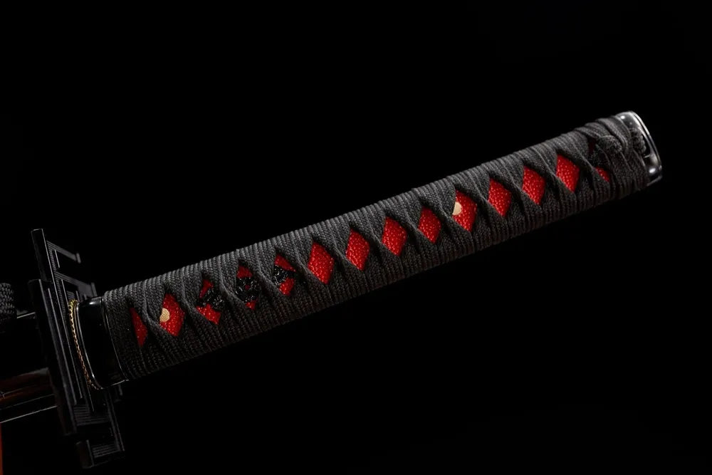 Top section black‑set tsuka front close‑up, black rounded kashira pommel