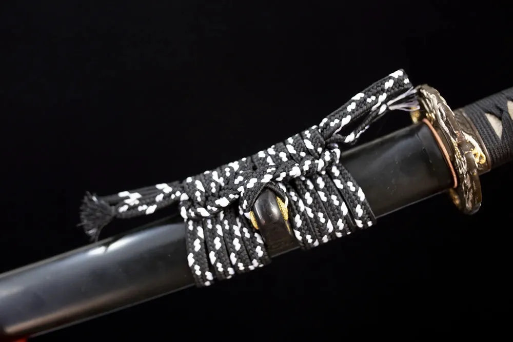 Thick black‑white mixed‑braided sageo cord two‑tone aged‑copper fitting macro close‑up