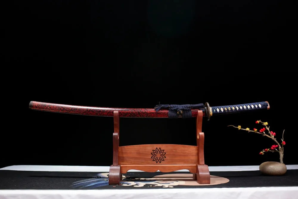 Horizontal laid closed charcoal‑gray silver‑etched storm‑cloud‑lightning Storm‑Katana scabbard flat table‑top front display