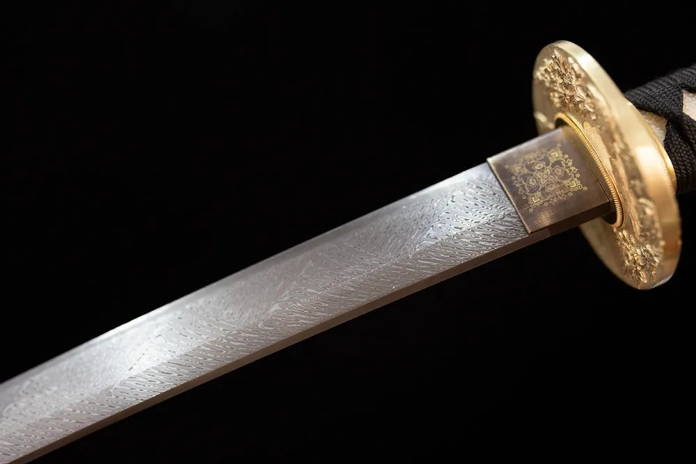 Upper T10 clay‑tempered katana blade brass habaki suguha‑gunome feather‑layer‑flowing undulating hamon temper‑line macro close‑up