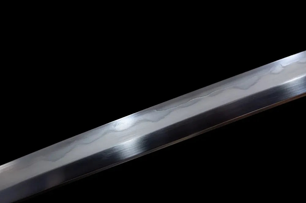 Mid‑section midare‑style irregular undulating hamon steel tachi blade surface close‑up shot