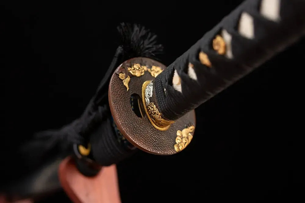 Reverse‑side cloud‑scroll‑beast carving aged‑bronze‑gilded tsuba surface texture close‑up