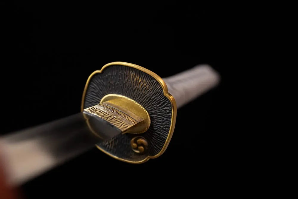 Front open‑work vortex‑kamon‑relief brass katana hand‑guard close‑up