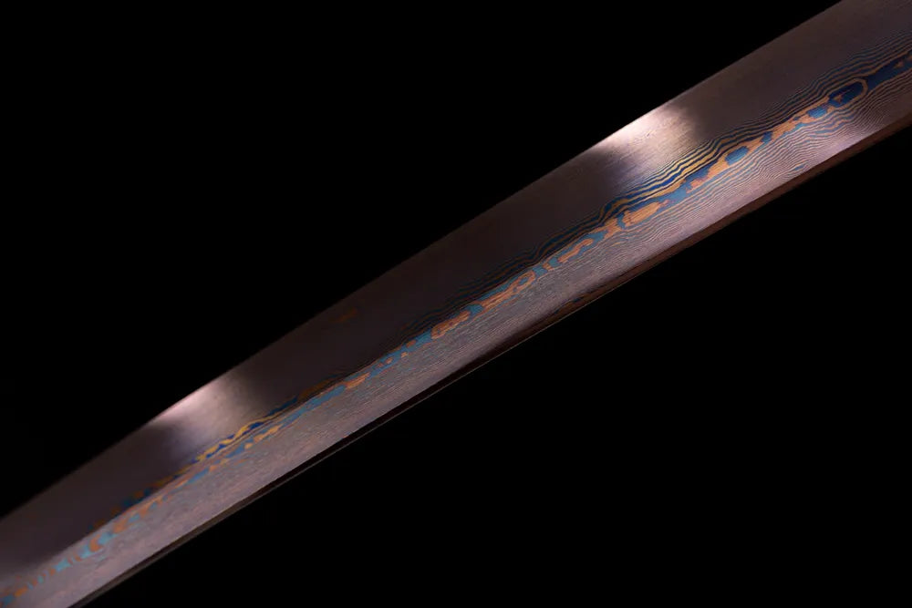 Mid‑section damascus folded layered grain tinted steel blade surface close‑up shot