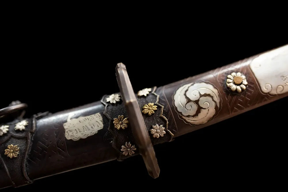 Mansion‑crest embossed brass‑alloy fuchi grip‑ring macro close‑up