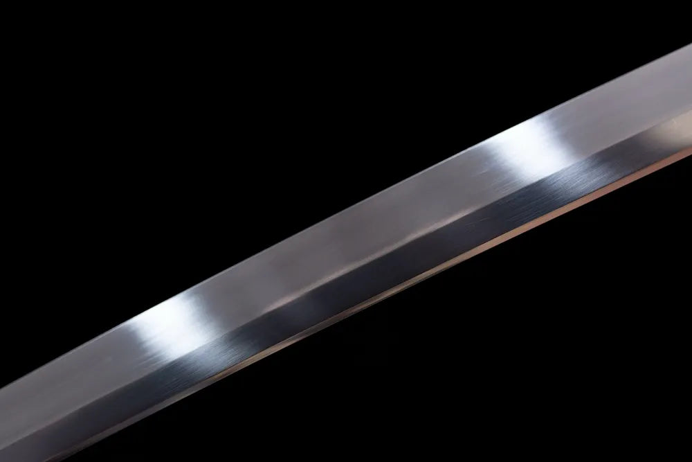 Mid‑section mirror‑polished 1060 high‑carbon steel tachi blade surface close‑up shot