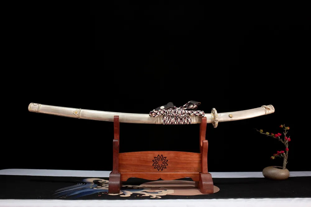 Horizontal laid closed matte‑silver‑white metallic‑maki‑e White‑Knight‑Tachi scabbard flat table‑top front display