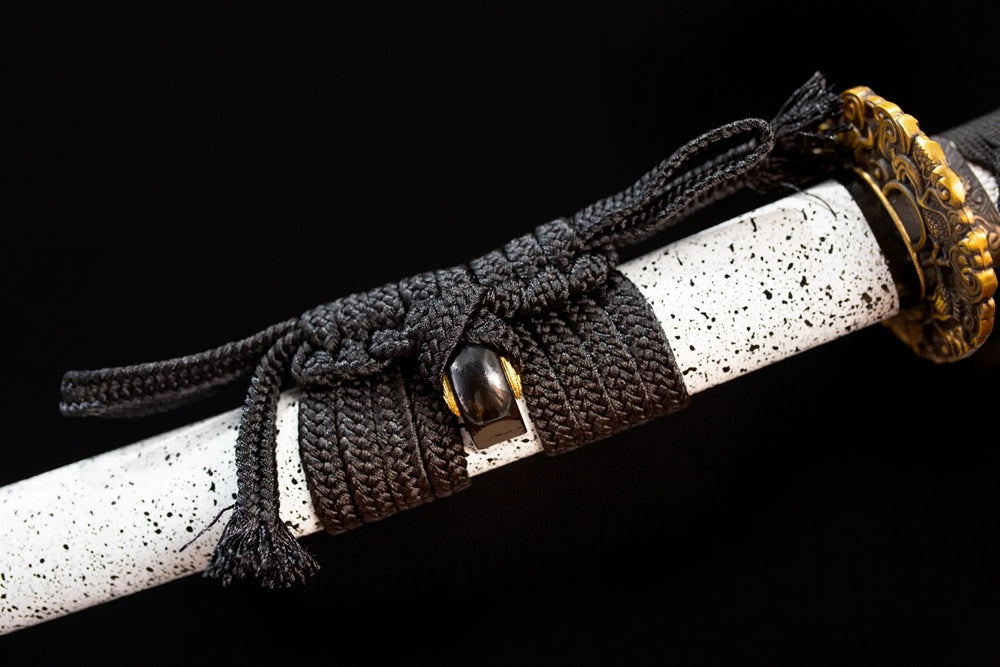 Thick deep‑black heavy‑braided sageo cord antique‑gilt‑bronze fitting macro close‑up