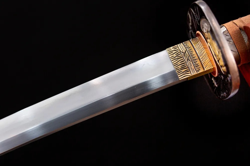 Upper kobuse‑damascus‑T10 clay‑tempered katana blade brass habaki gunome undulating‑wave hamon temper‑line macro close‑up