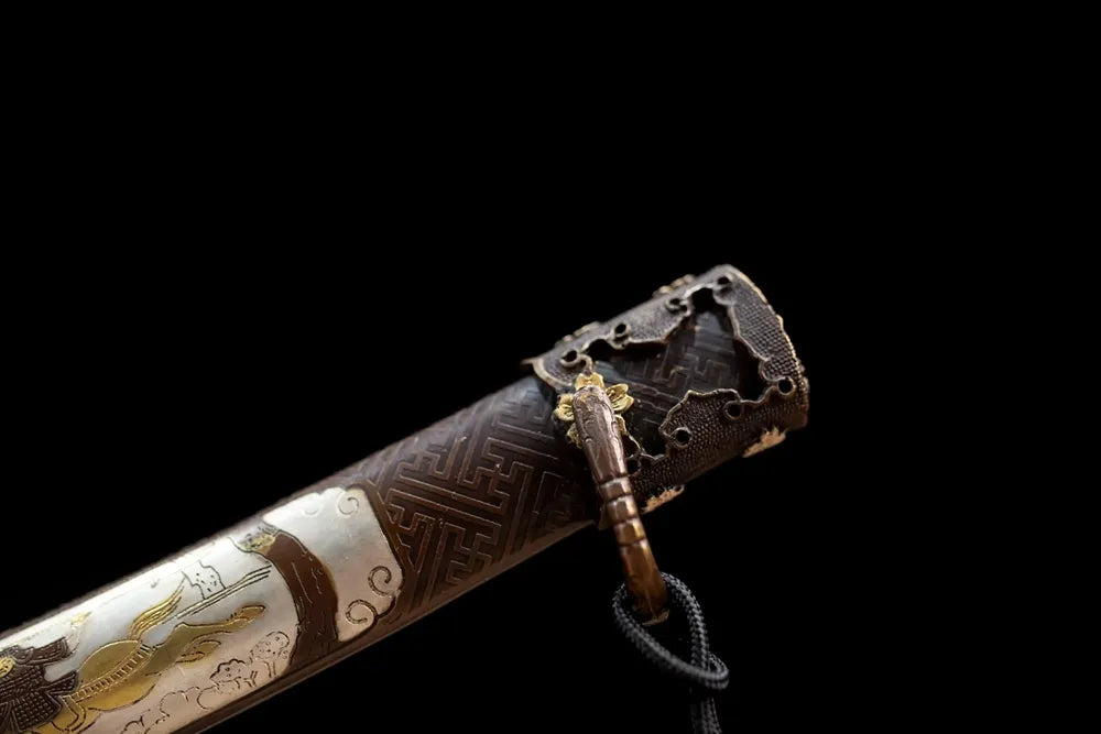Top mansion‑crest embossed brass‑alloy kashira pommel front close‑up