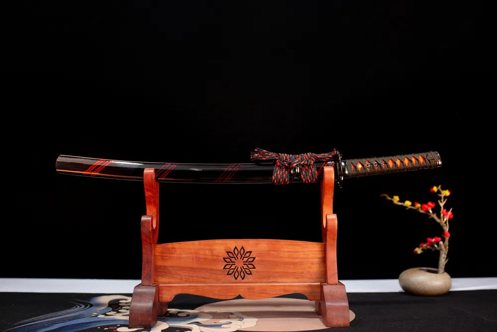 Horizontal laid closed high‑gloss‑black crimson‑wisp‑red‑streak Wisp‑Red‑Wakizashi scabbard flat table‑top front display