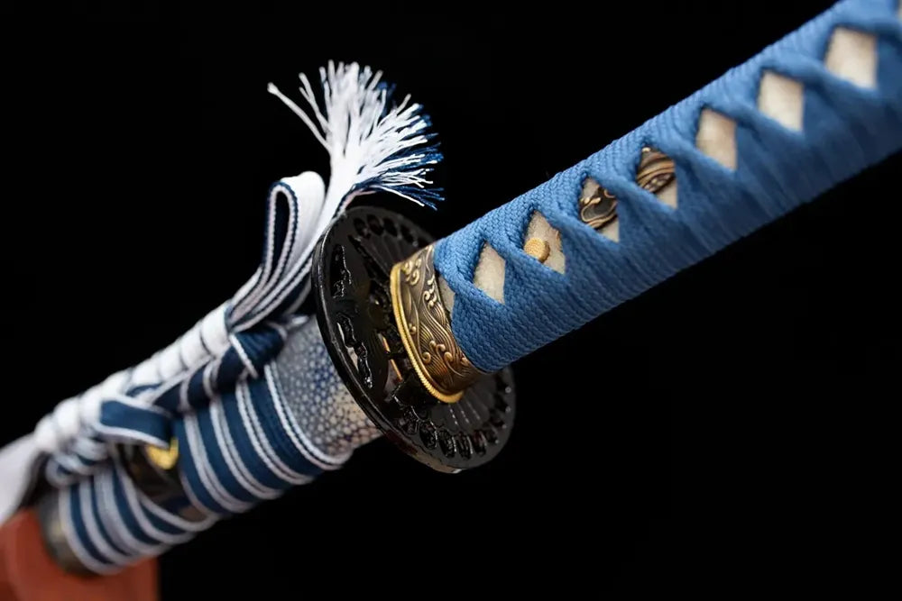 Reverse‑side butterfly‑flight‑scroll carving black‑openwork‑brass tsuba surface texture close‑up