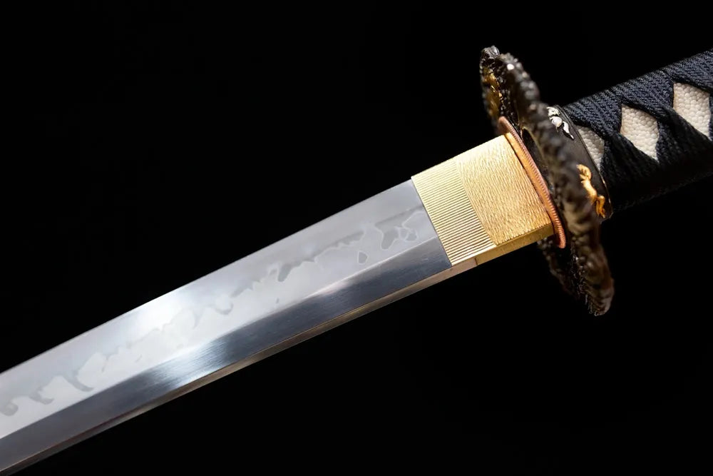 Upper T10 clay‑tempered katana blade brass habaki distinct yahazu‑style hamon temper‑line macro close‑up