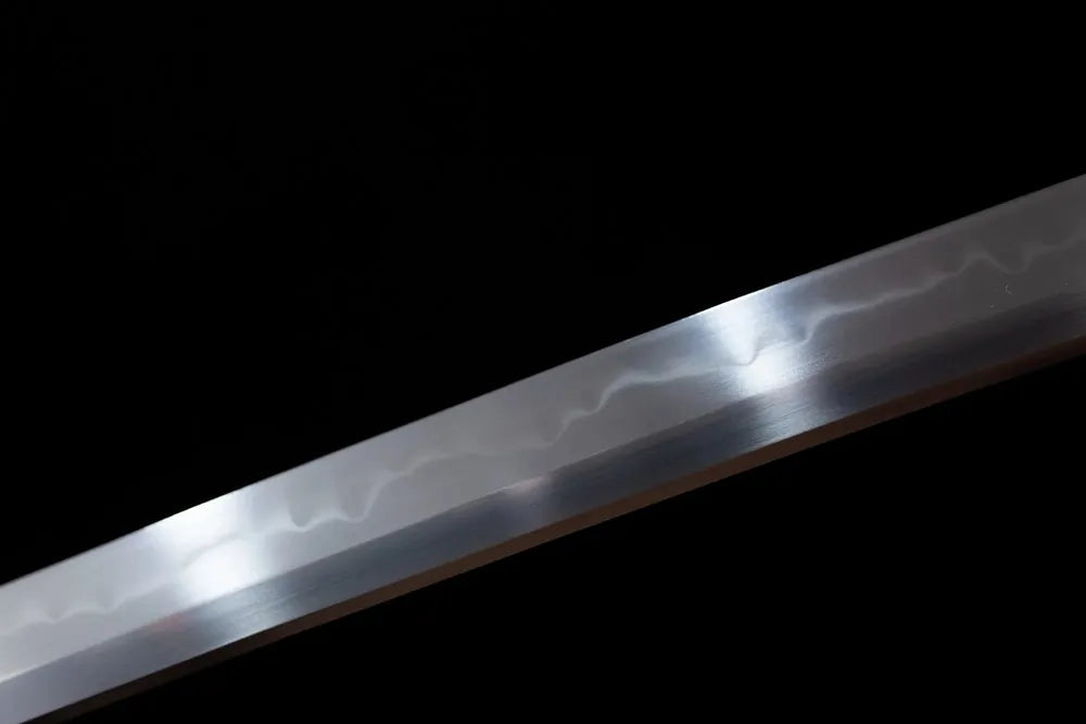 Mid‑section suguha‑gunome lively‑insect‑undulating‑pattern hamon steel katana blade surface close‑up shot