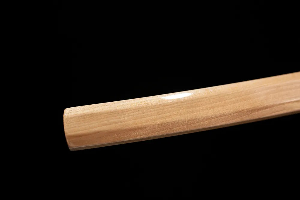 Bottom raw‑unpainted natural‑wood shirasaya saya plain wood end‑cap close‑up