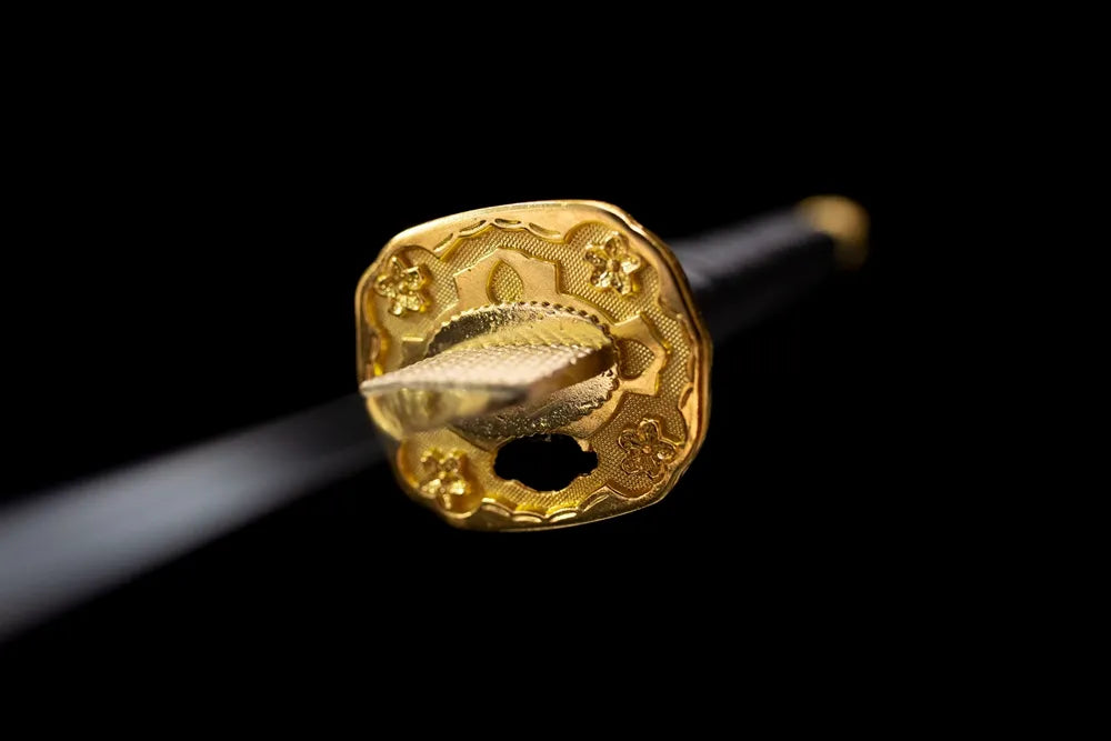 Front open‑work chrysanthemum‑mon gilded‑brass tachi hand‑guard close‑up