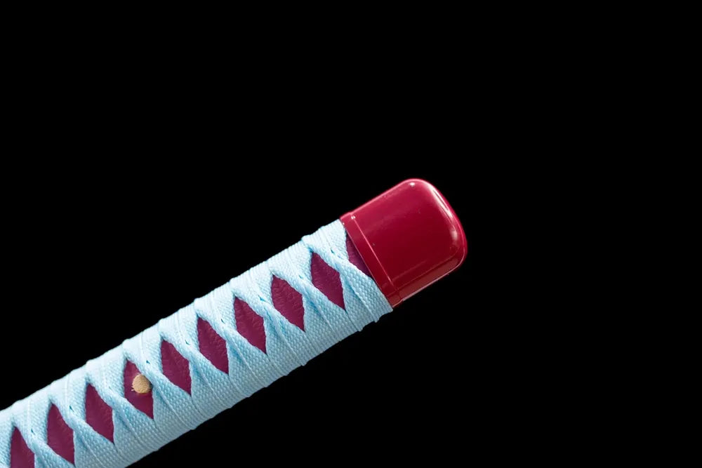 Top magenta‑red alloy kashira pommel front close‑up