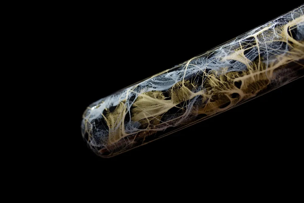 Bottom agate‑veined saya translucent resin‑hardwood end‑cap close‑up