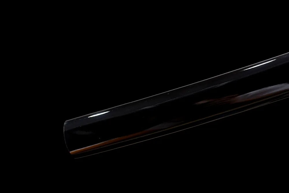 Bottom glossy solid‑black saya matte‑black alloy kojiri end cap close‑up