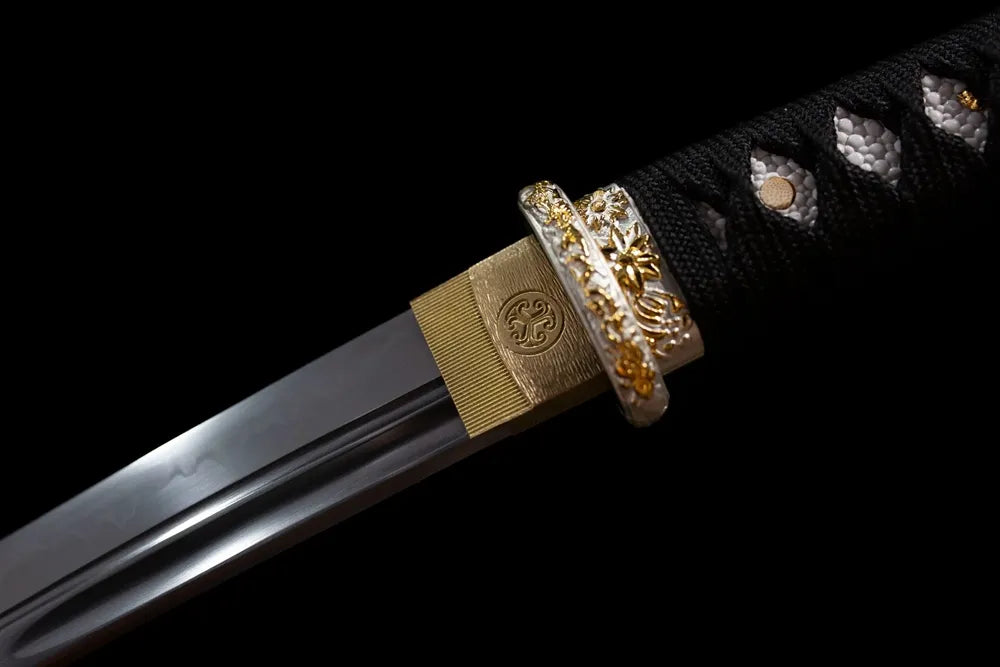 Upper T10 clay‑tempered wakizashi blade brass habaki wavy hamon temper‑line macro close‑up