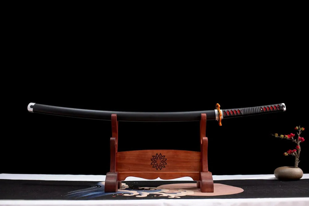 Horizontal laid closed matte‑black Tanjirou second‑gen scabbard flat table‑top front display