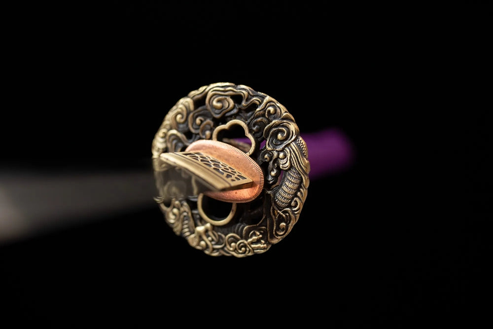 Front open‑work wisteria‑scroll‑relief purple‑toned purple‑gild katana hand‑guard close‑up