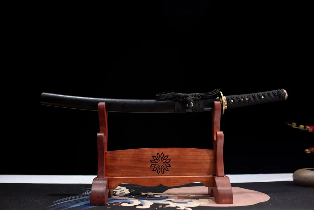 Horizontal laid closed textured black Diamond wakizashi scabbard flat table‑top front display