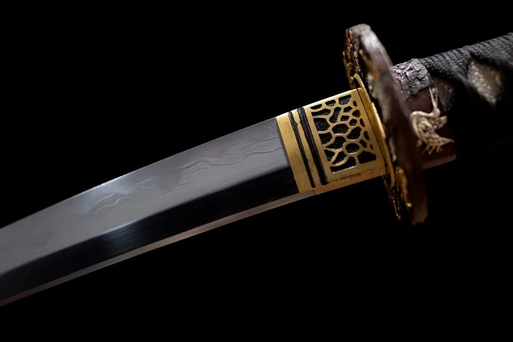 Upper T10 clay‑tempered wakizashi blade brass habaki suji‑gunome mixed‑style hamon temper‑line macro close‑up