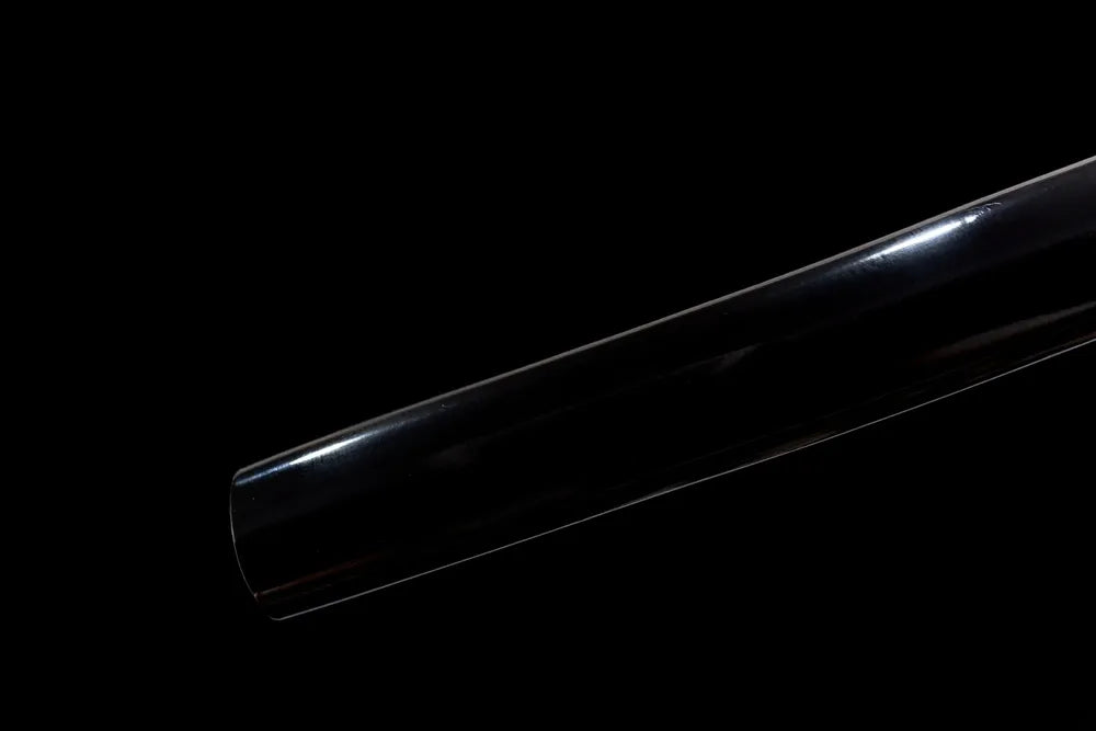 Bottom polished black scabbard end cap close-up