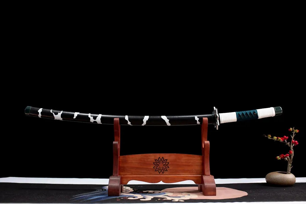 Horizontal laid closed black wind‑gust‑print Sanemi scabbard flat table‑top front display